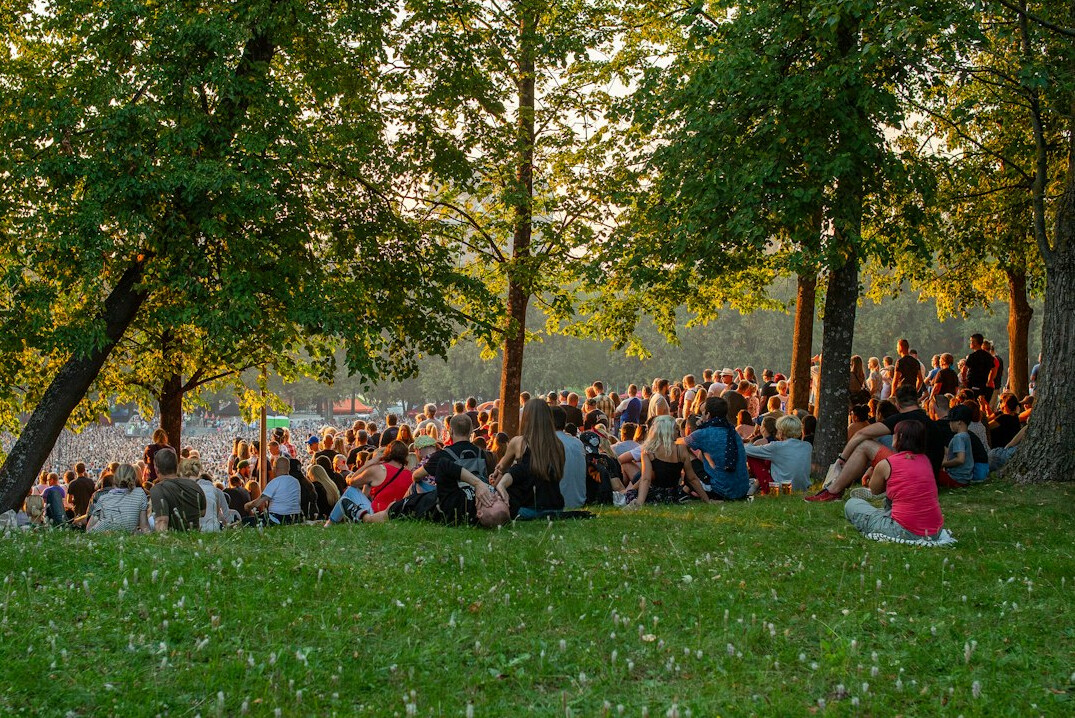Outdoor music festival crowd at sunset