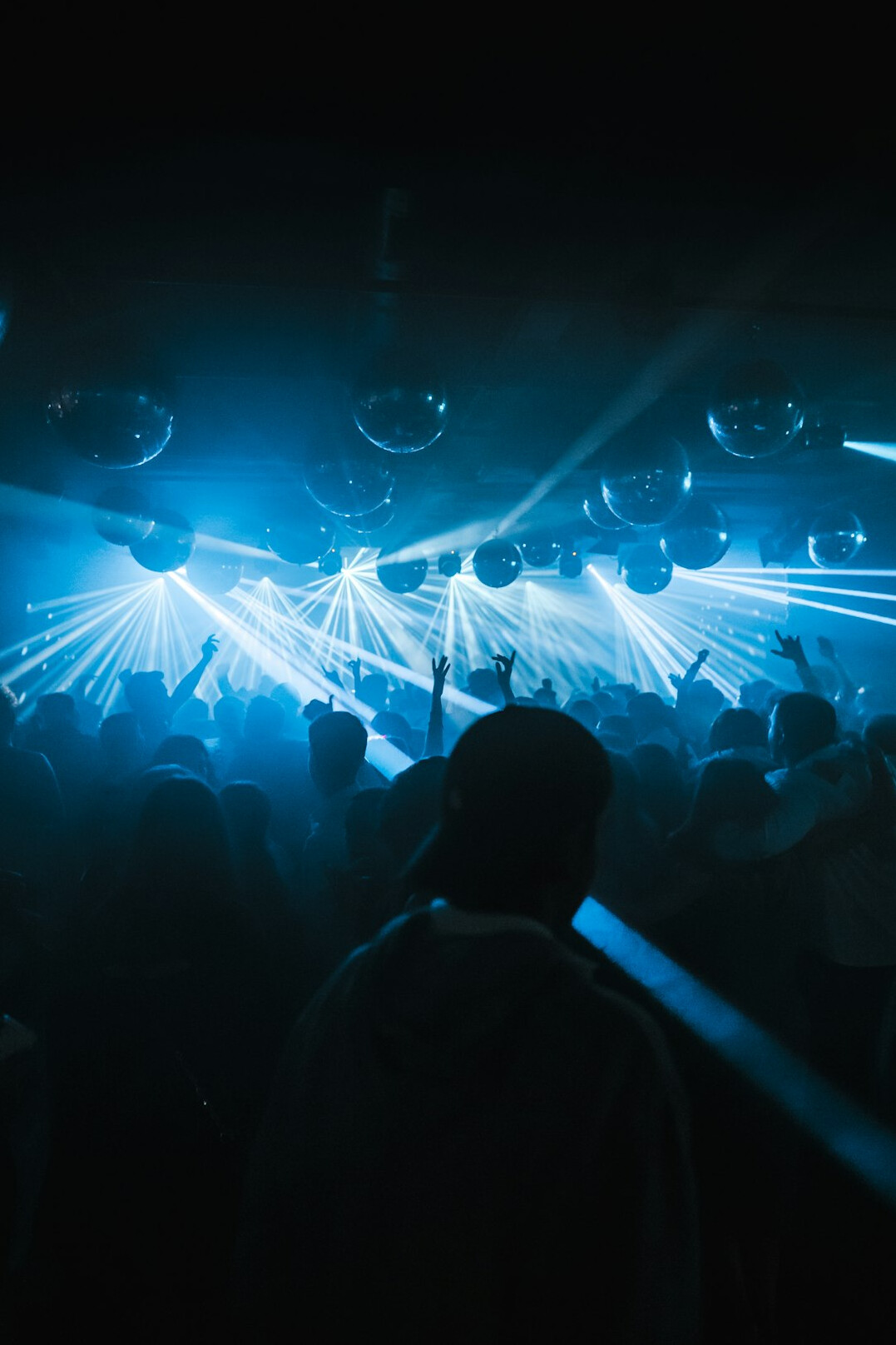 Large event crowd with dramatic stage lighting